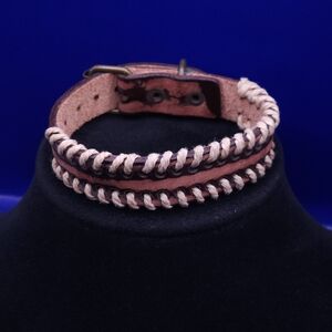 leather cuff bracelet with natural lacing and a buckle closure